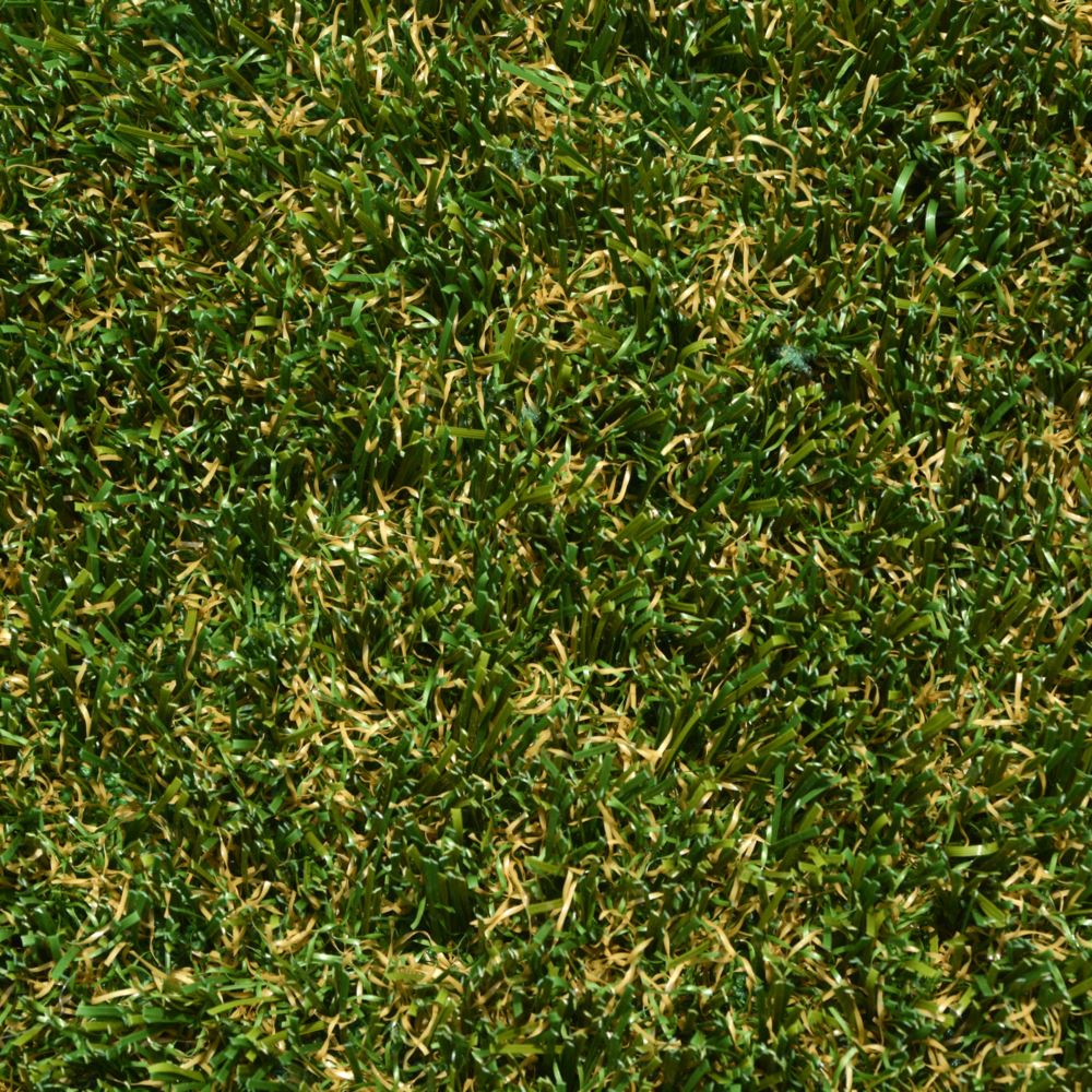 Close up image of artificial grass that is green with some brown strands.